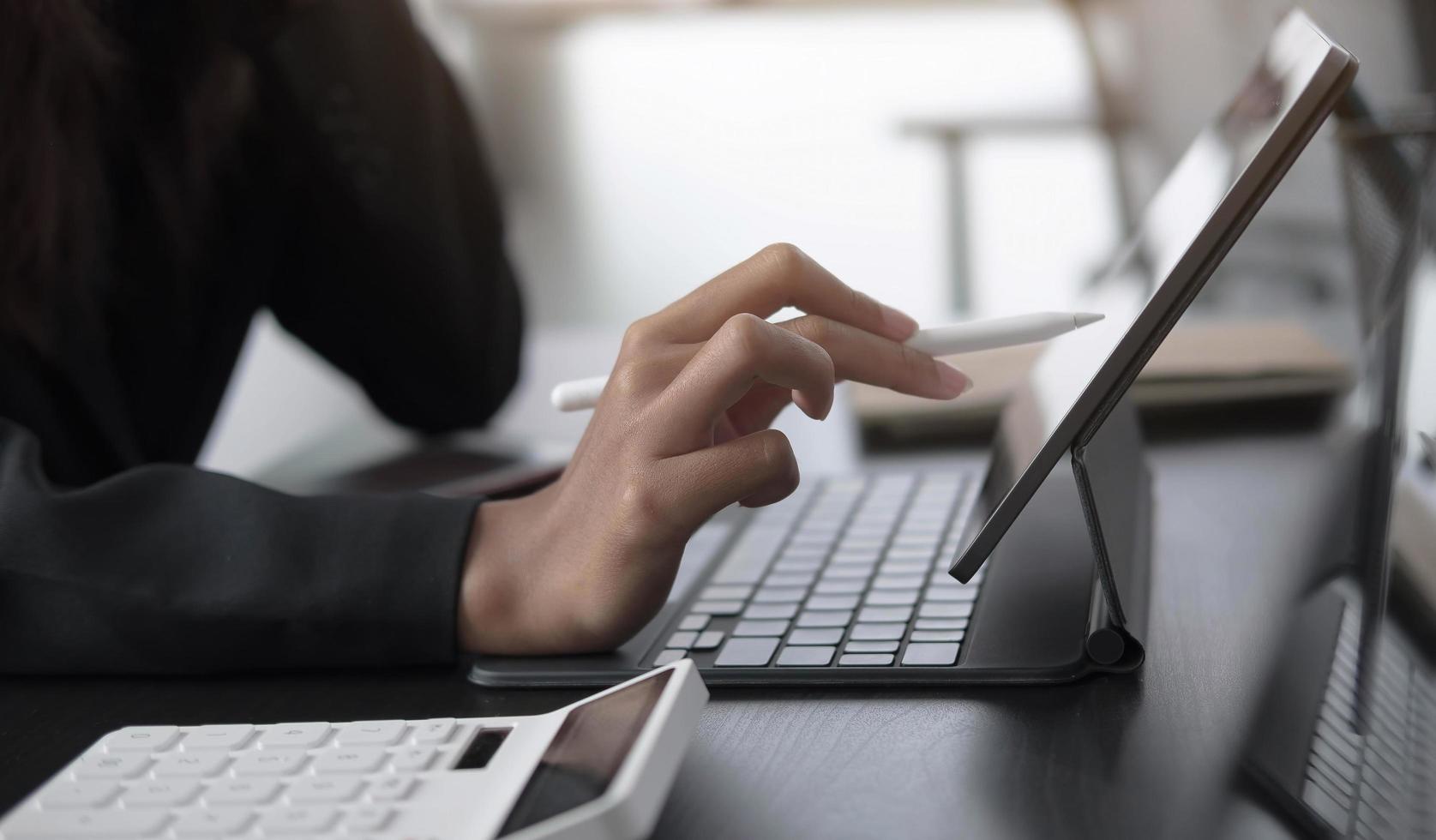 Close-up of a person using a touch screen on a tablet photo