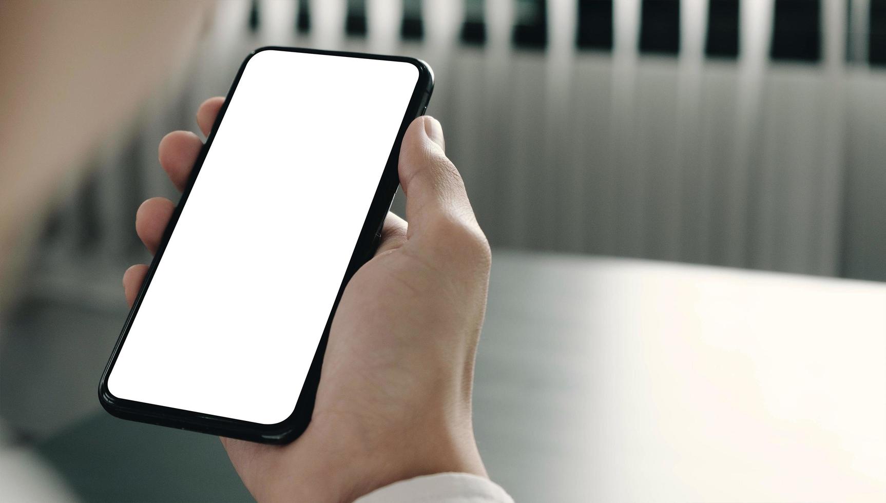 Person looking at smartphone mock-up photo