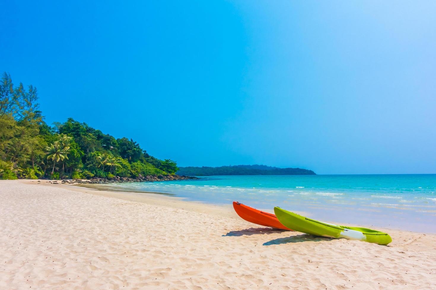 Colorful kayak boat on beach and sea photo