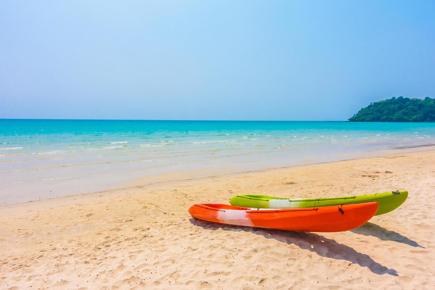 Colorful kayak boat on beach and sea photo