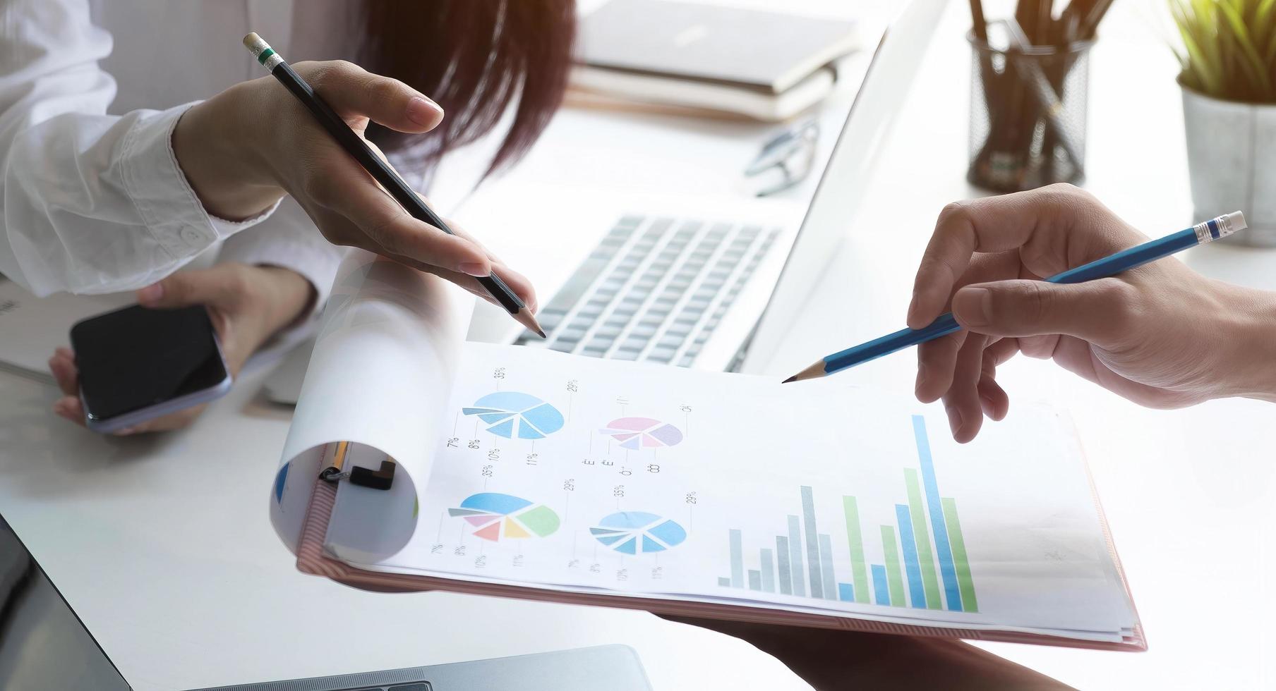 Coworkers discussing charts photo