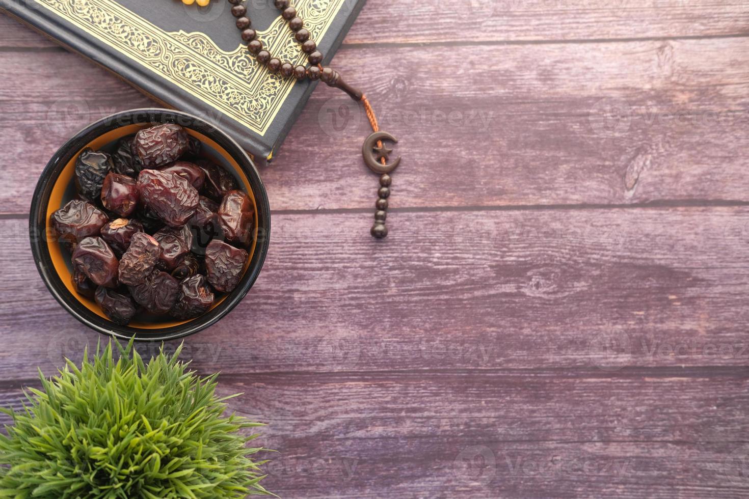 Quran with rosary and dates photo