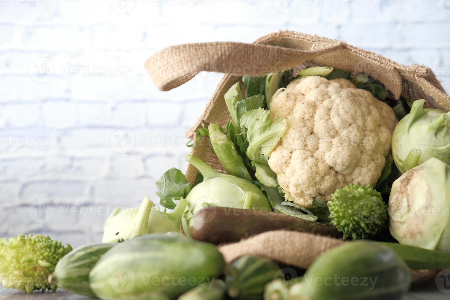 Vegetables against a white brick wall photo
