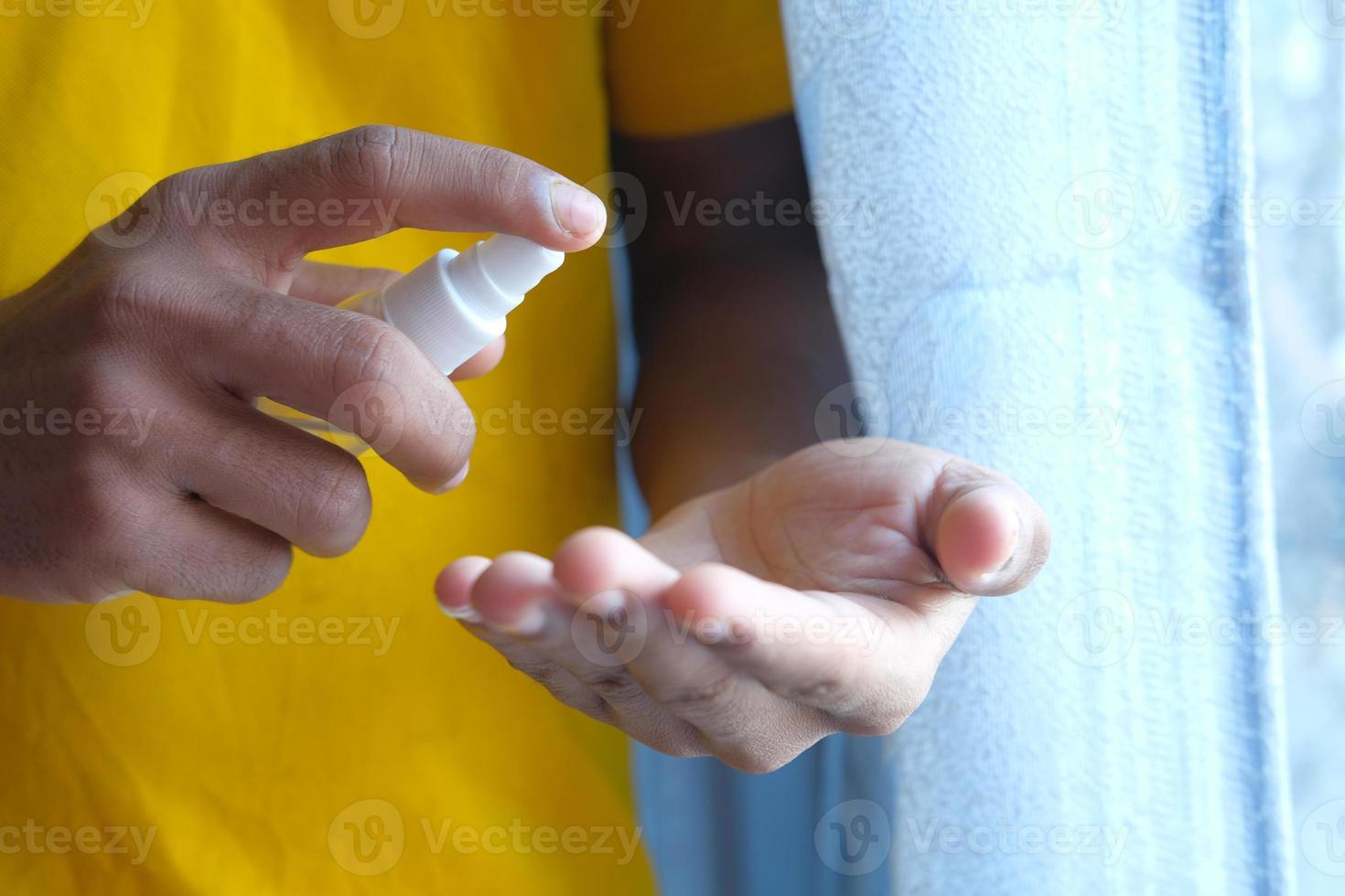 Person sanitizing their hands photo