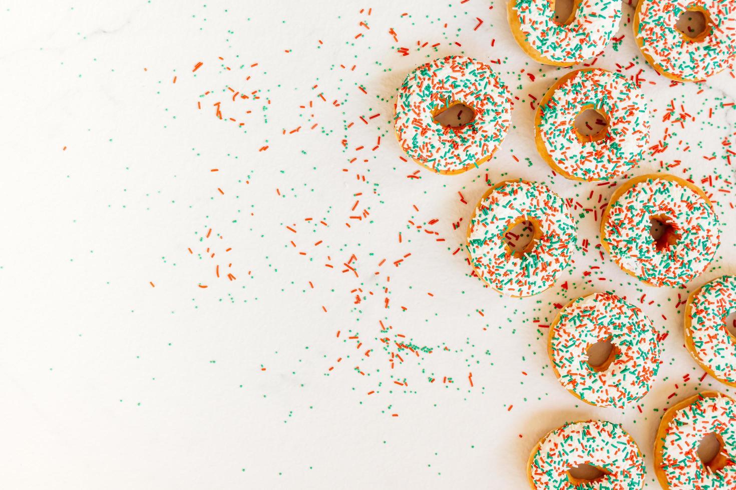 Donuts with white chocolate cream and sprinkles sugar photo
