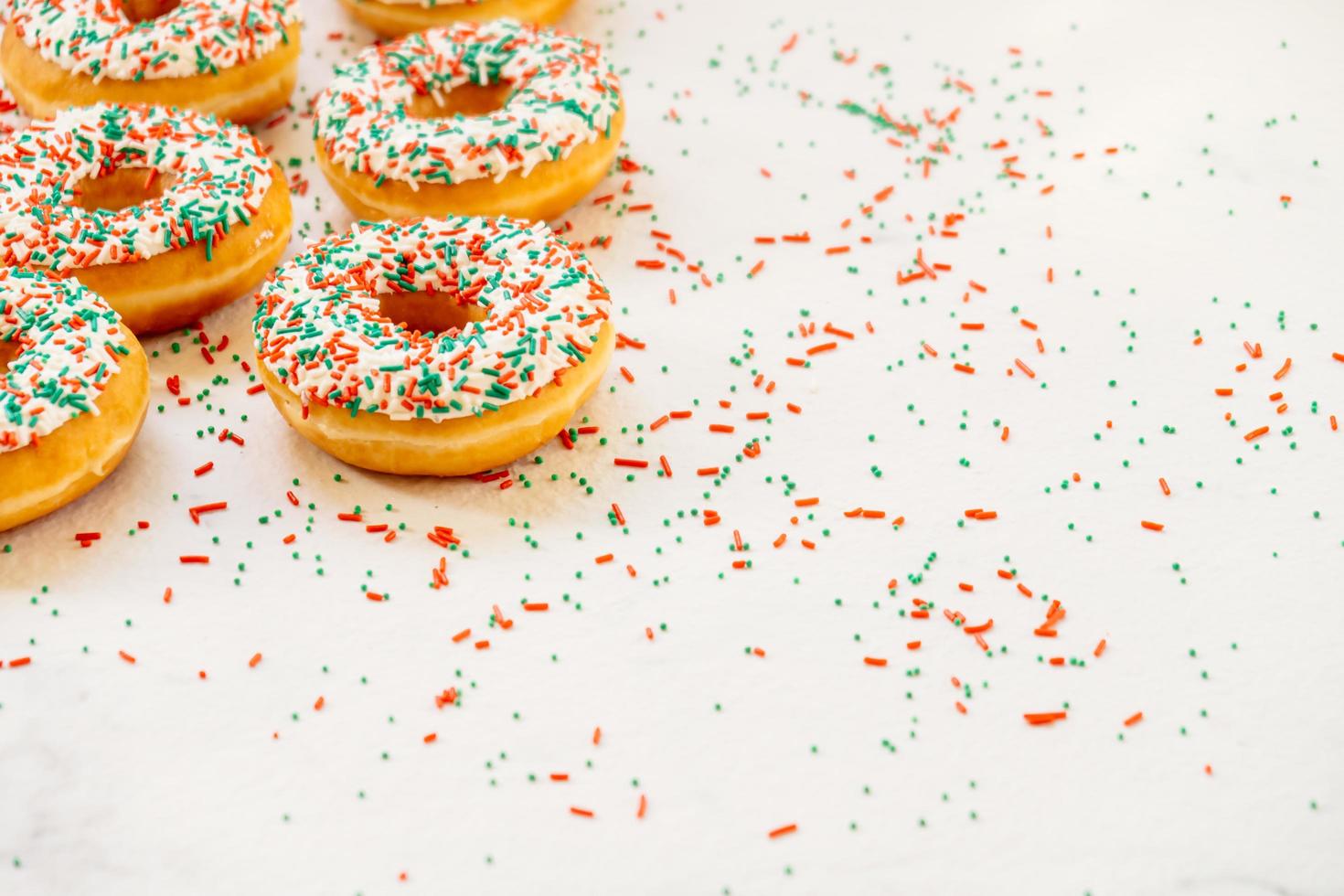 Donuts with white chocolate cream and sprinkles sugar photo