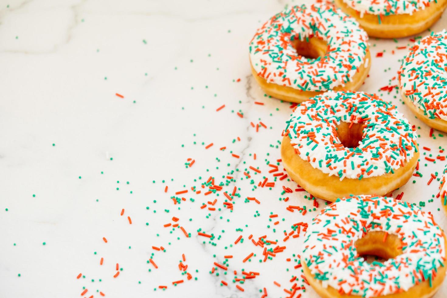 Donuts with white chocolate cream and sprinkles sugar photo