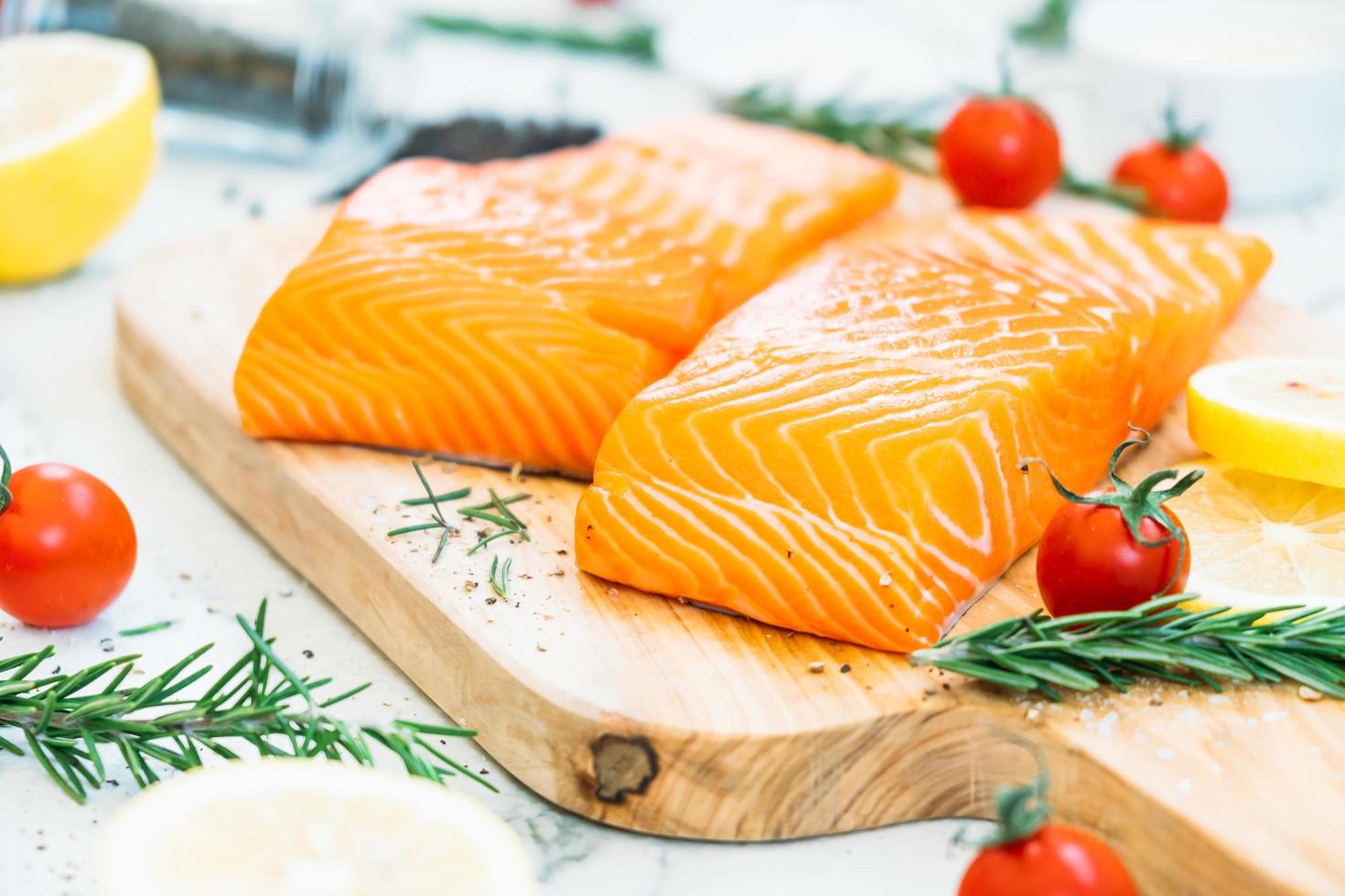 Raw and fresh salmon meat fillet on wooden cutting board photo