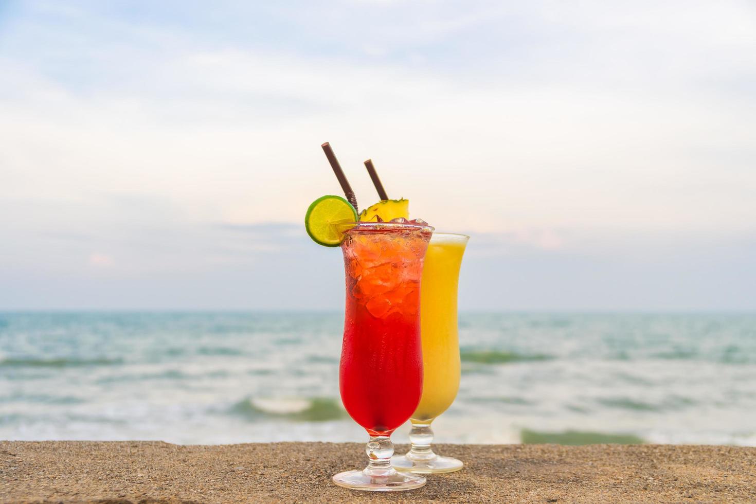 Iced cocktails drinking glass on the beach photo