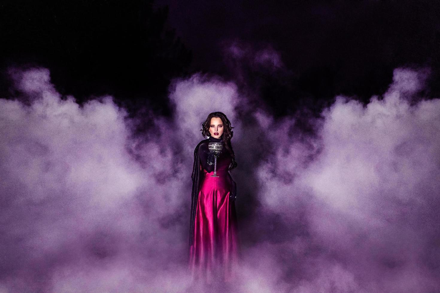 Girl alone at night in the forest brews a potion and wonders for marriage photo