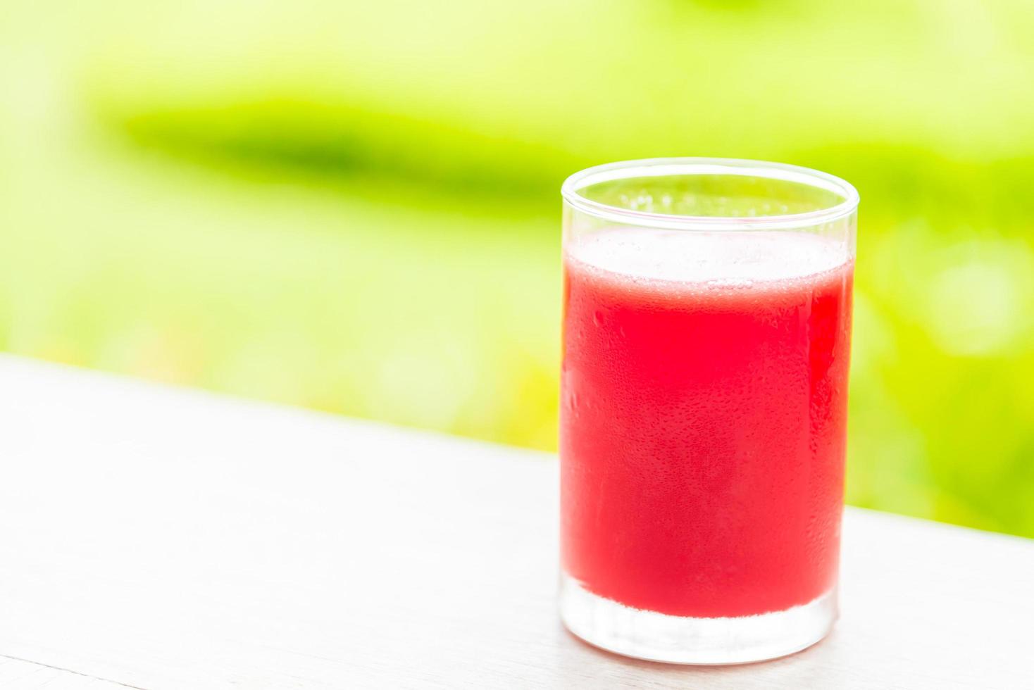 Watermelon juice glass with outdoor view background photo