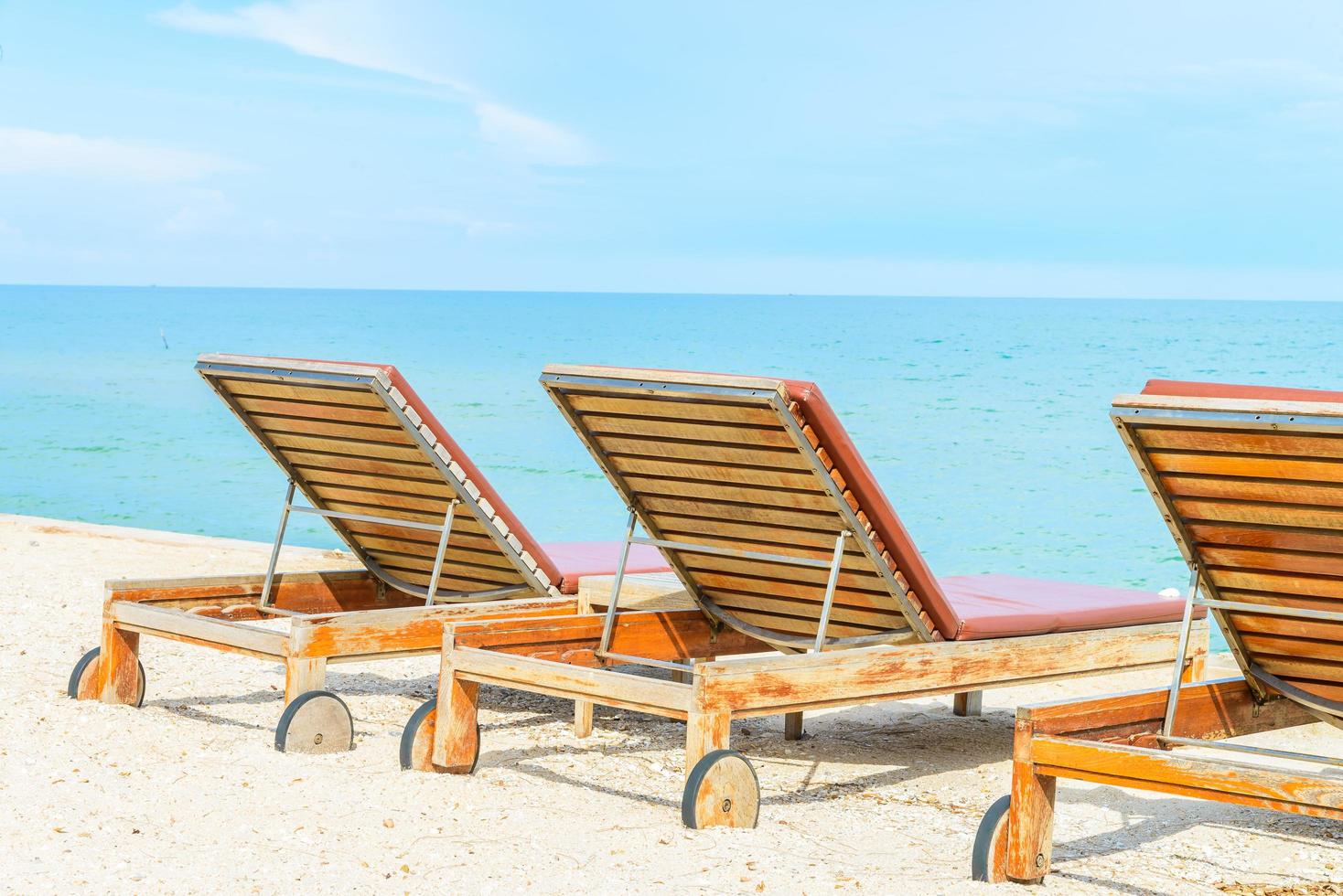 Sunbathing beds on a tropical beach photo