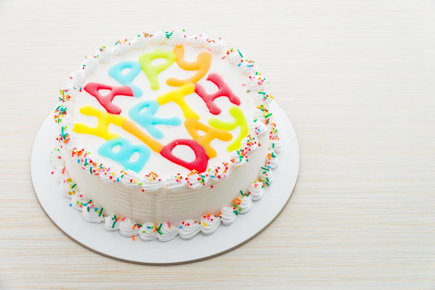Happy birthday cake on wooden background photo