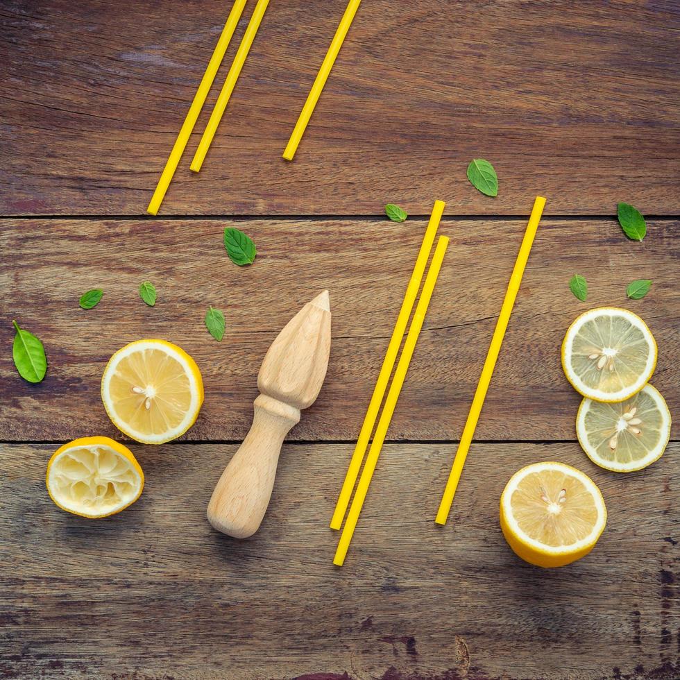 Fresh lemon sliced and peppermint leaves set up on shabby wooden background flat lay photo