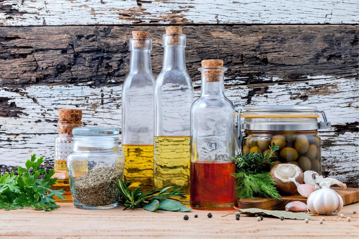 Different sorts of cooking oils on old wooden background photo