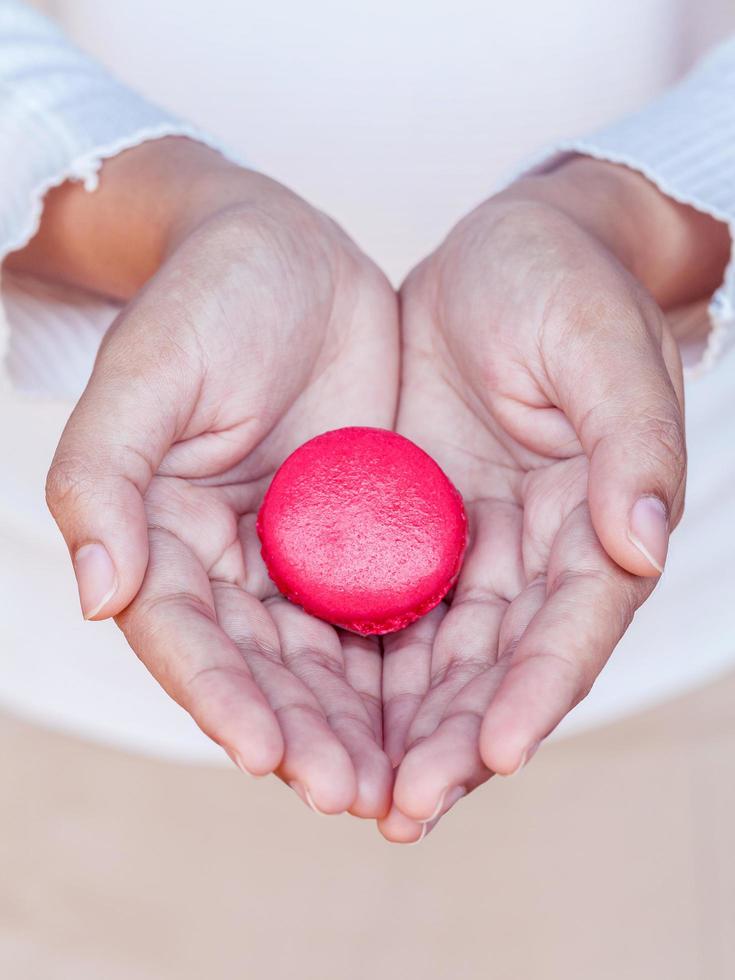 Female hands holding french macaroons photo