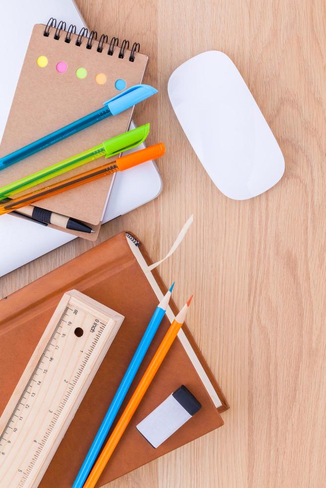 Back to school concept with school supplies on wooden table photo