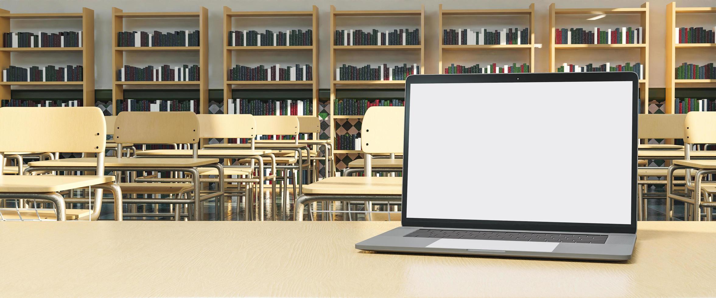 Maqueta de computadora portátil en la mesa del maestro con escritorios en el fondo foto