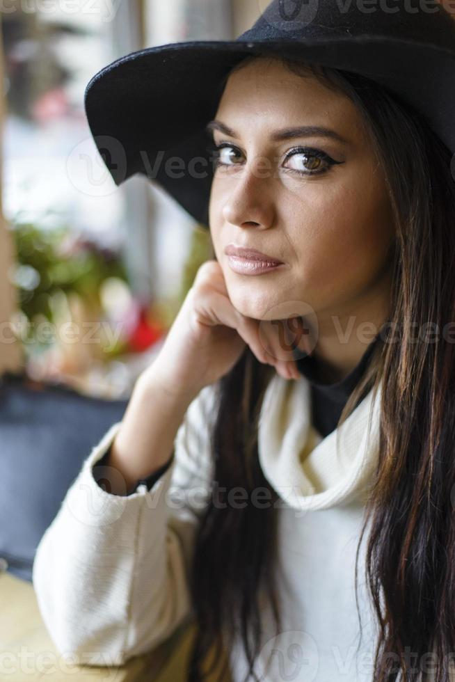 Pretty young woman with a hat photo