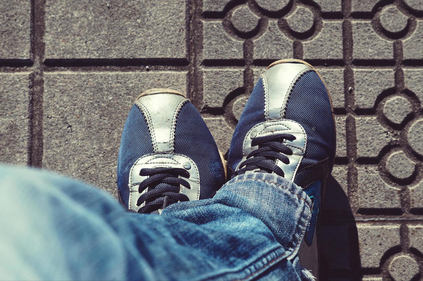 Man with sneakers walking on the street photo