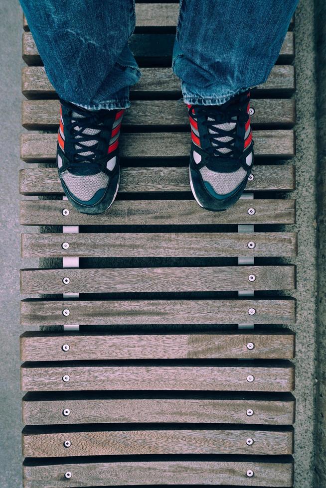 Man with sneakers walking on the street photo