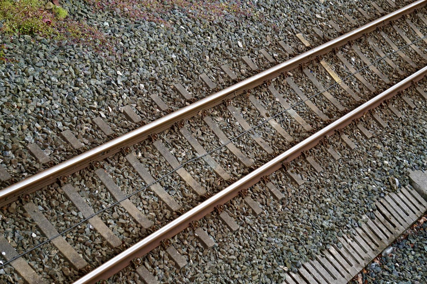 Railroad track in the station, train mode of transportation photo