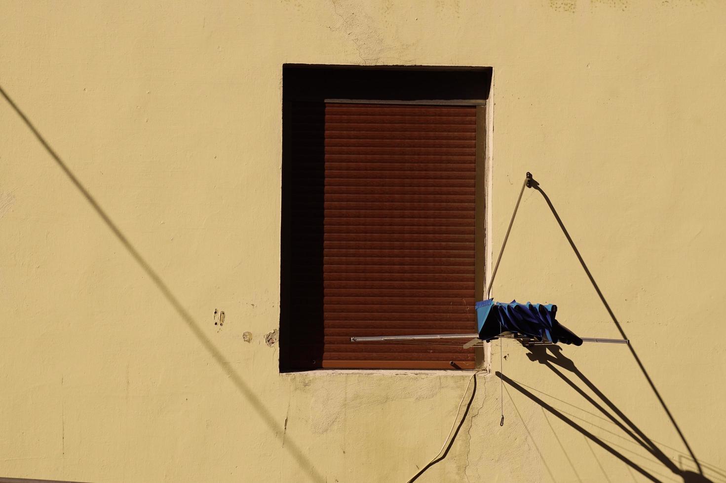 Window on the yellow facade of the house, architecture in Bilbao city, Spain photo