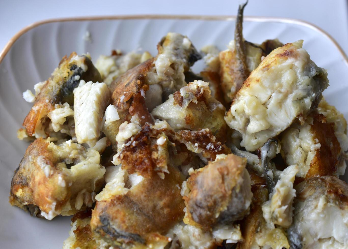 Toasted delicious pollock fish in a plate in the kitchen photo