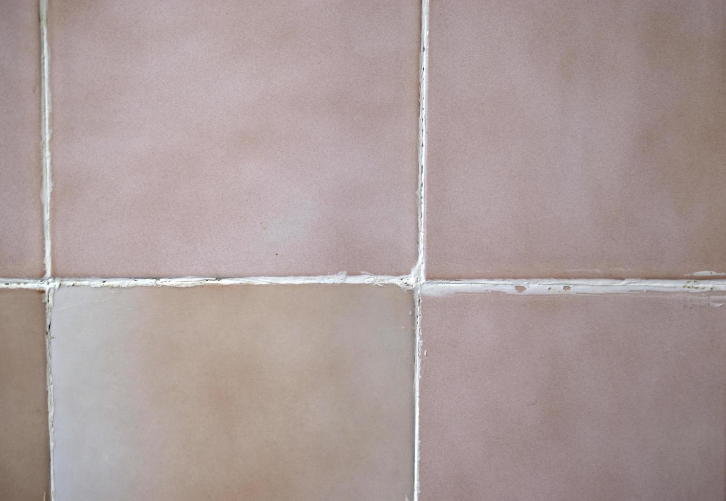 Old brown tile on the wall close-up photo