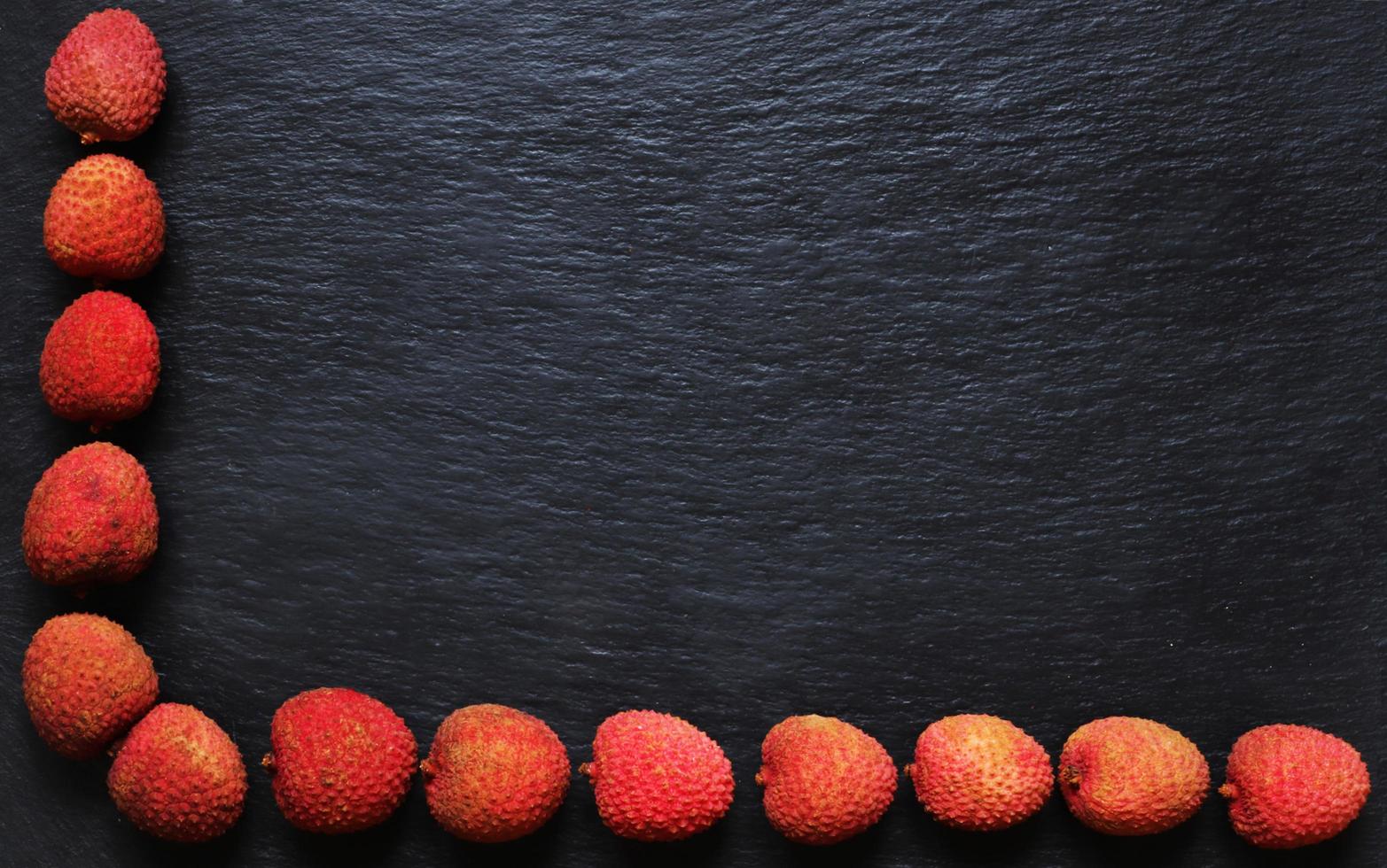 Litchis on slate background for menus, labels, or signs photo