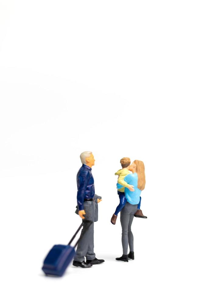 Miniature people, happy family standing on a white background and copy space for text photo