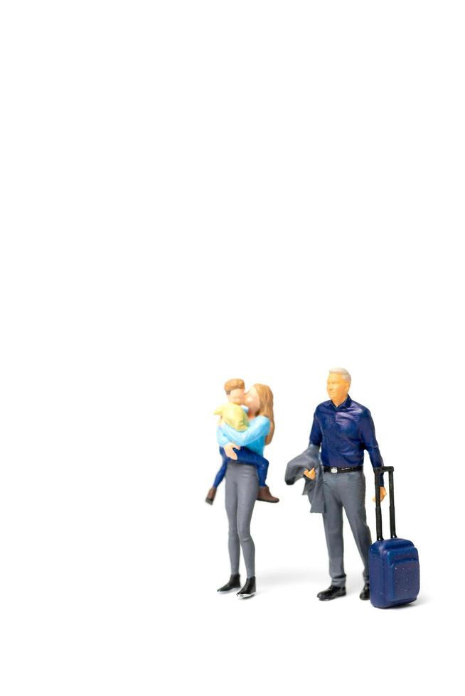 Miniature people, happy family standing on a white background and copy space for text photo