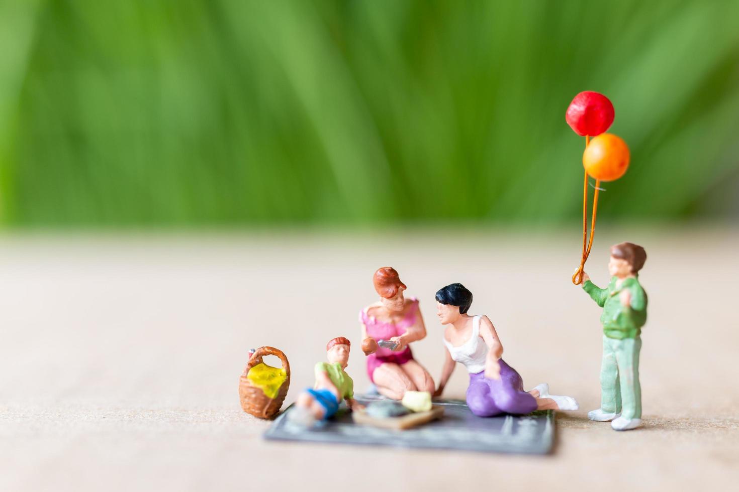 Miniature people, a beautiful couple of lesbian ladies having fun in the park with children photo