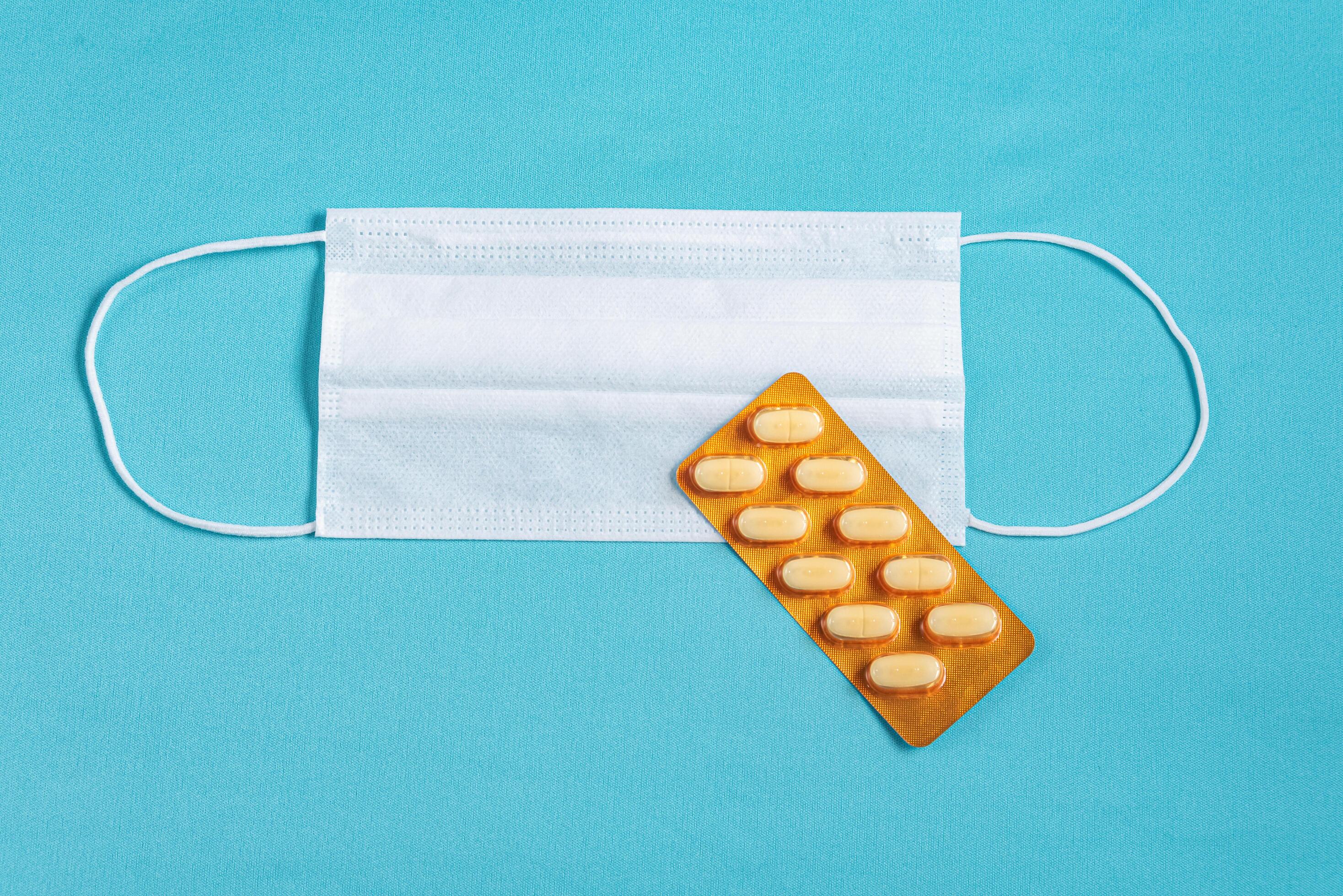 Surgical mask over minimalist blue background 2287566 Stock Photo at