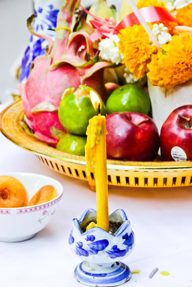 Yellow candle, incense pot and candles burning photo