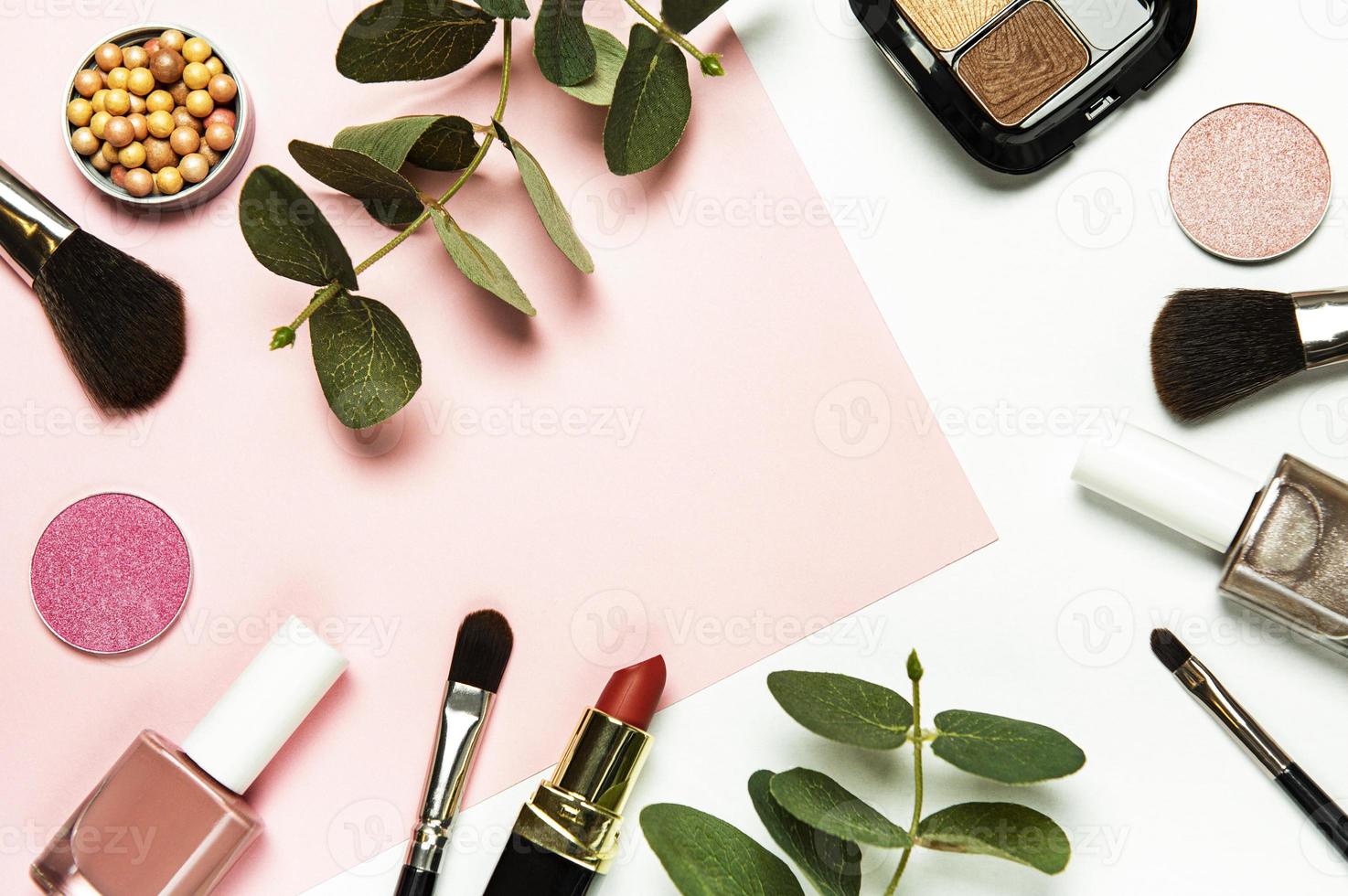 Cosmetics on a white and pink background photo