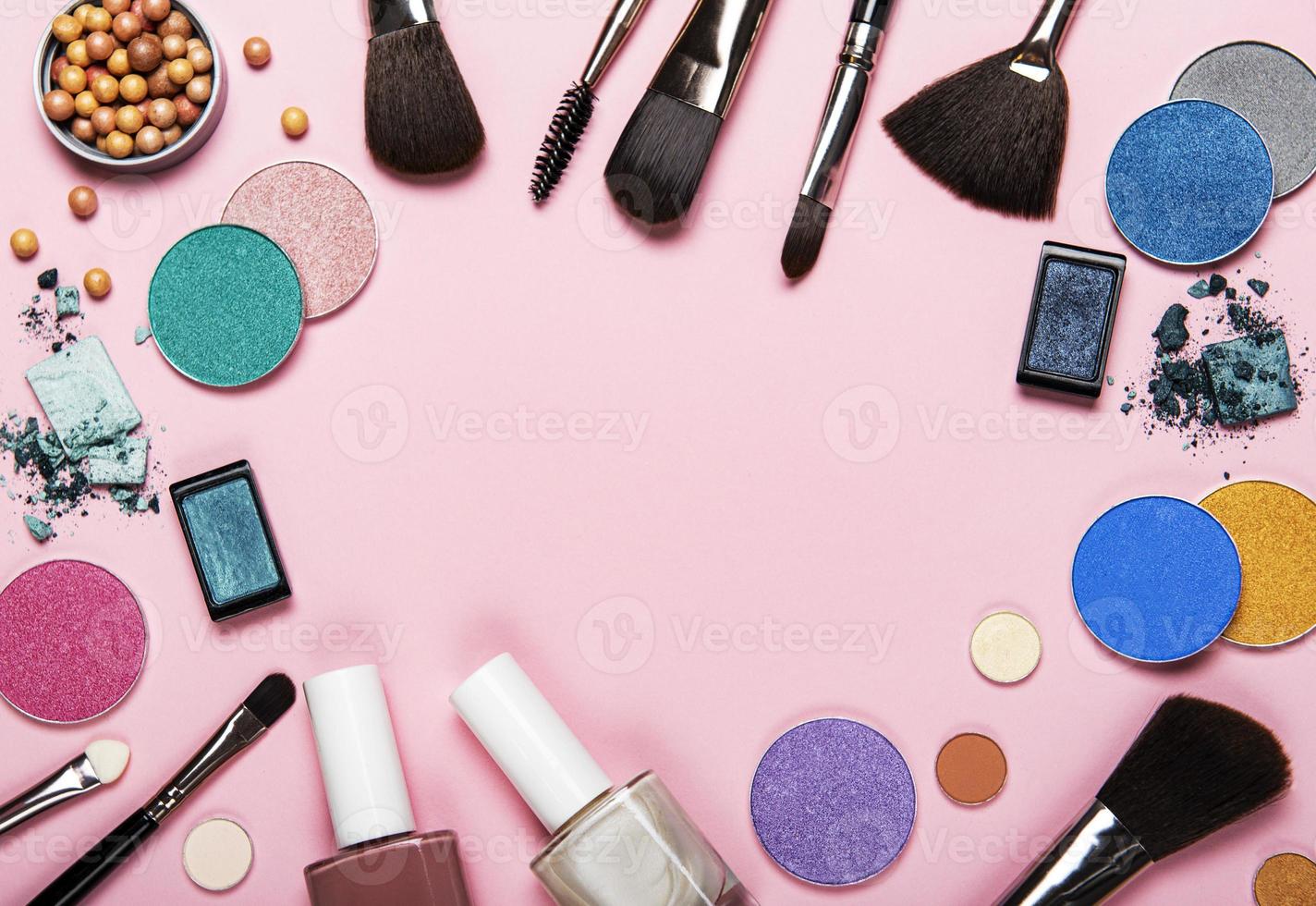 Cosmetics frame on a pink background photo