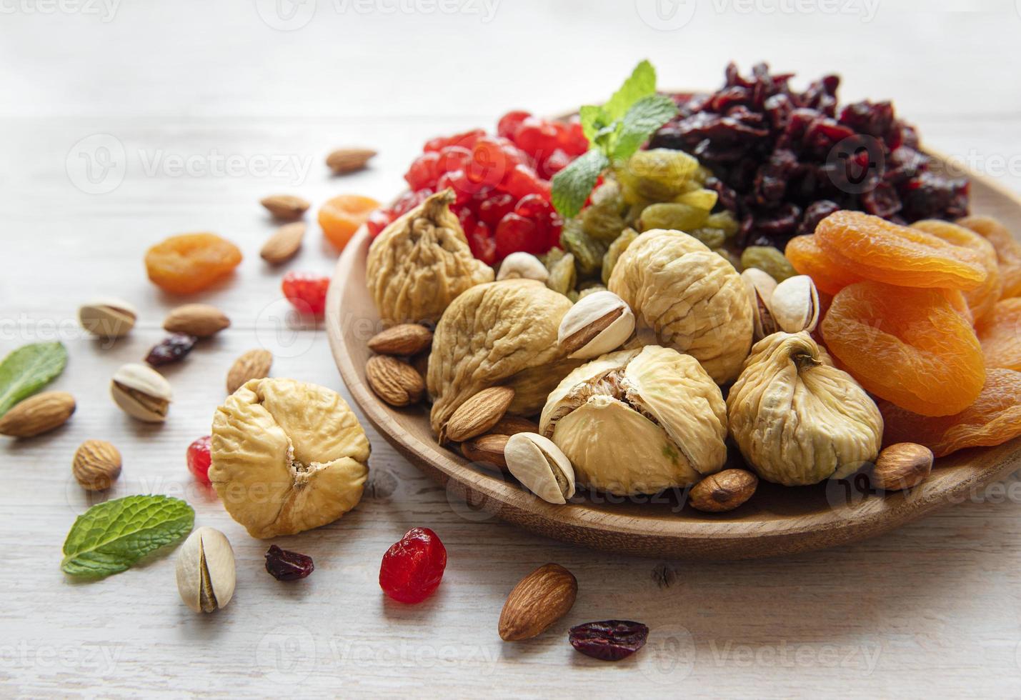 Bowl with various dried fruits and nuts photo