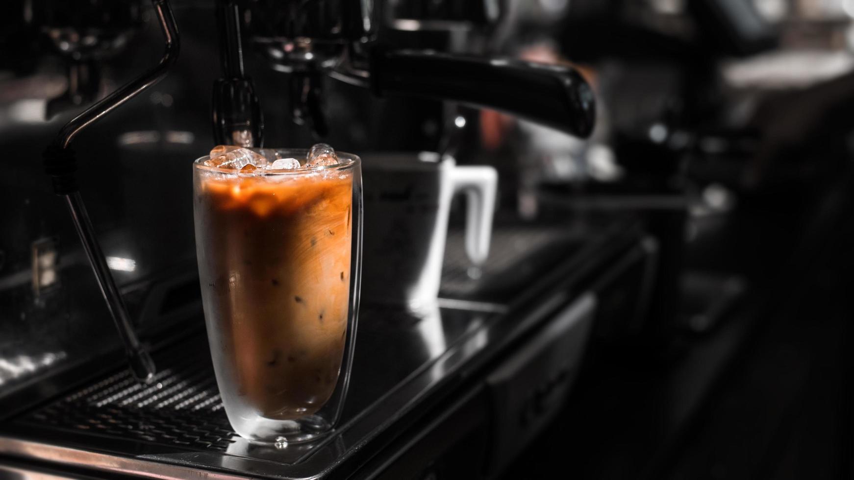 Close-up glass of iced coffee with milk on the table photo