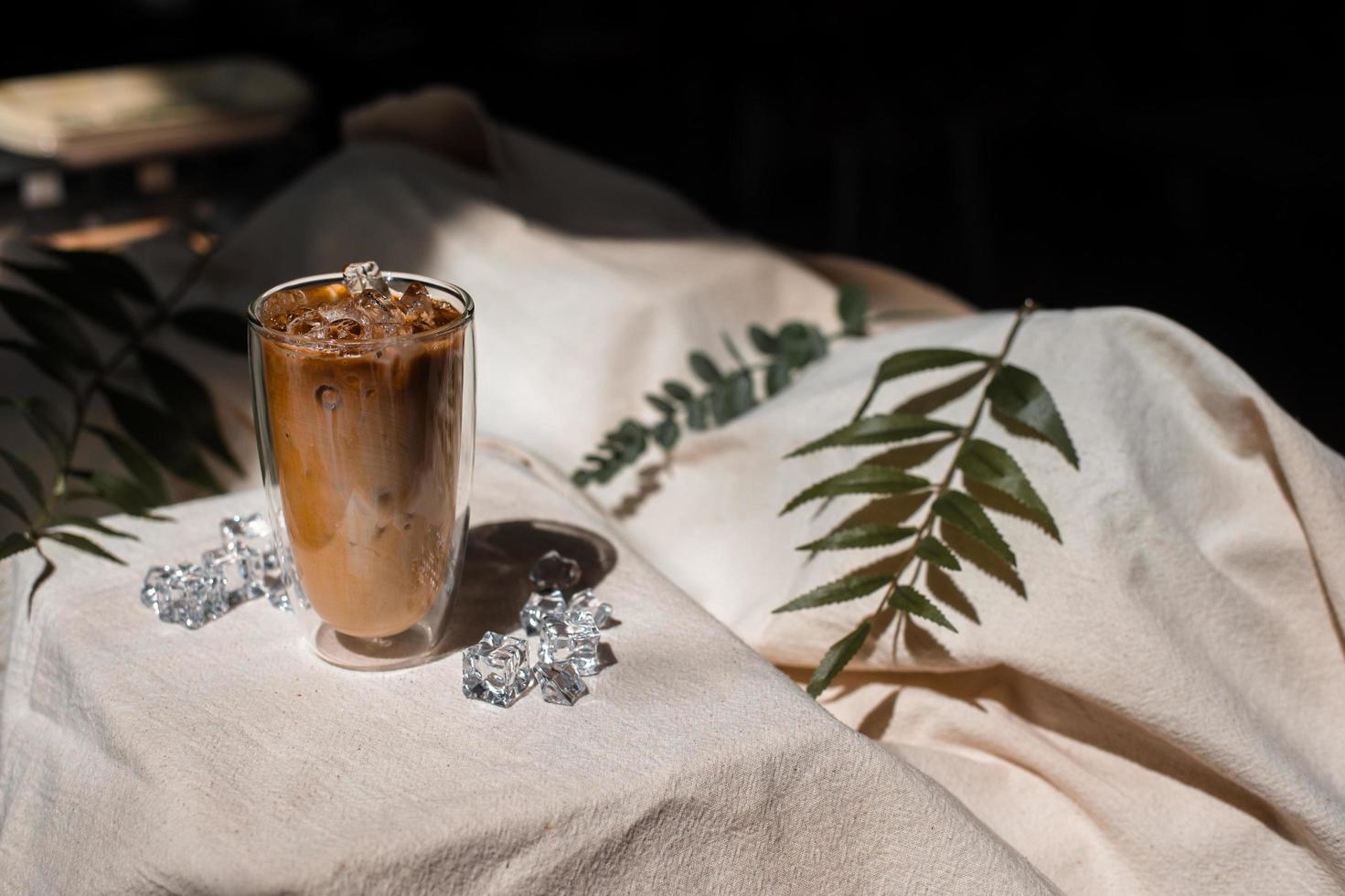 Close-up glass of iced coffee with milk on the table photo