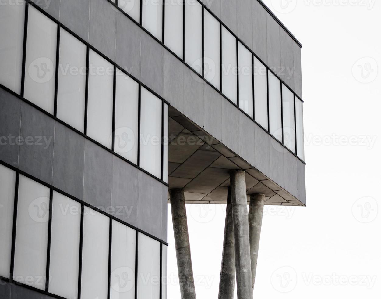 Gray concrete structure with columns and empty windows photo