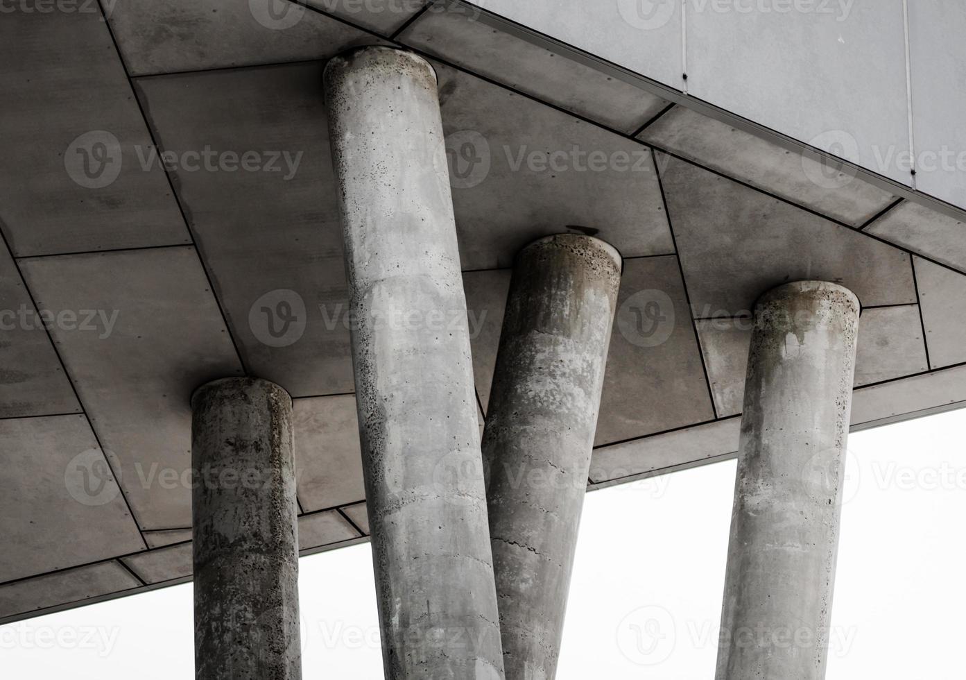 Fragment of gray concrete building with columns photo