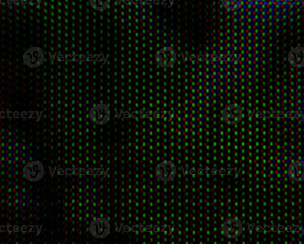 Abstract background pattern of colored blurry dots on a dark background close up photo