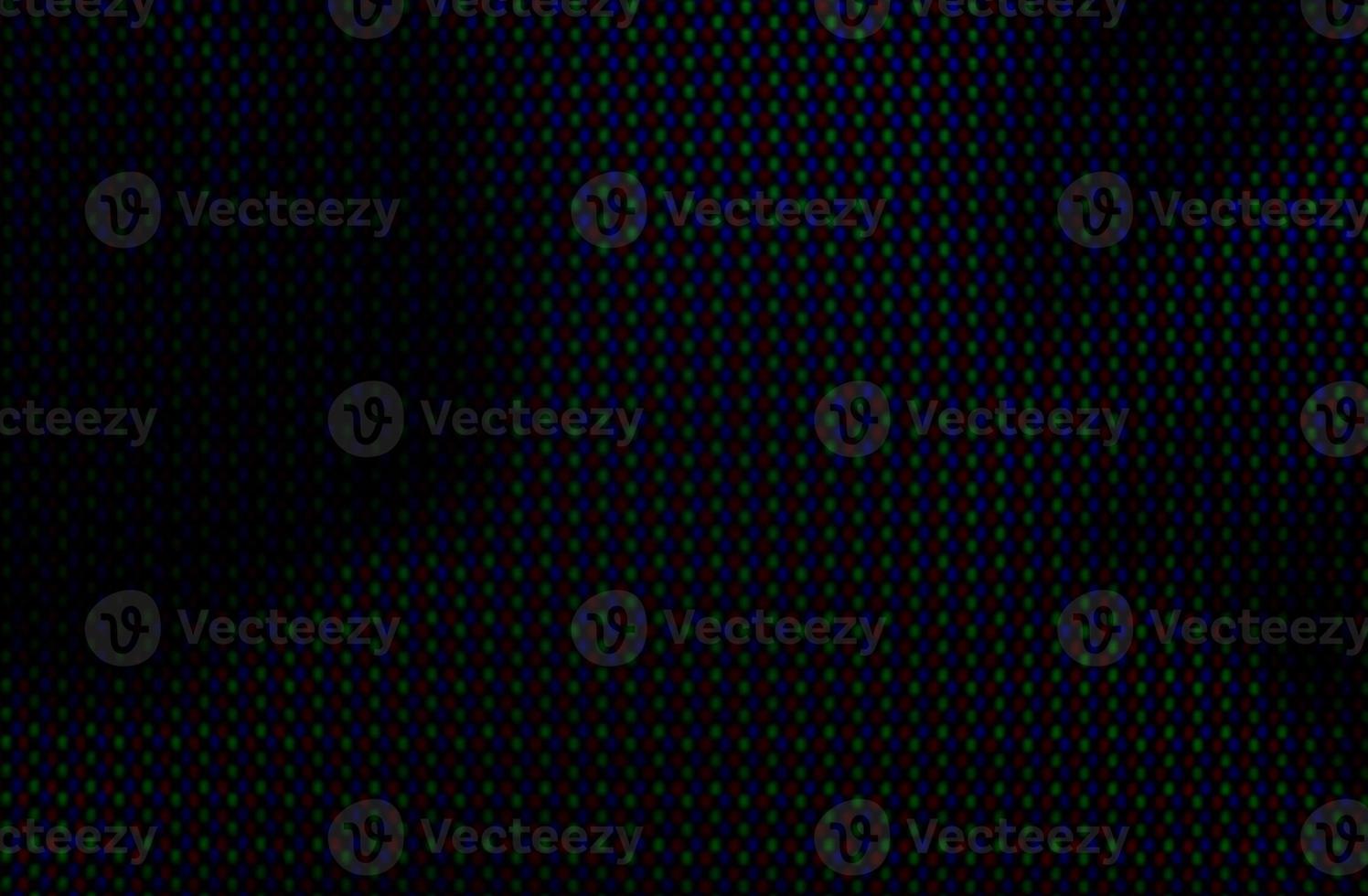 Abstract background pattern of colored blurry dots on a dark background close up photo