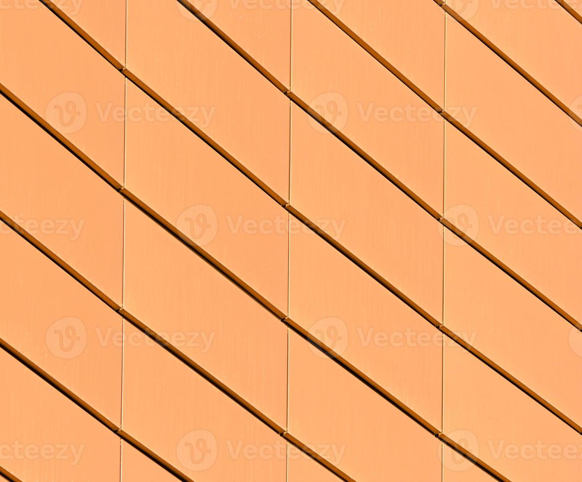 Architectural abstract pattern fragment of a wall of a yellow modern building photo