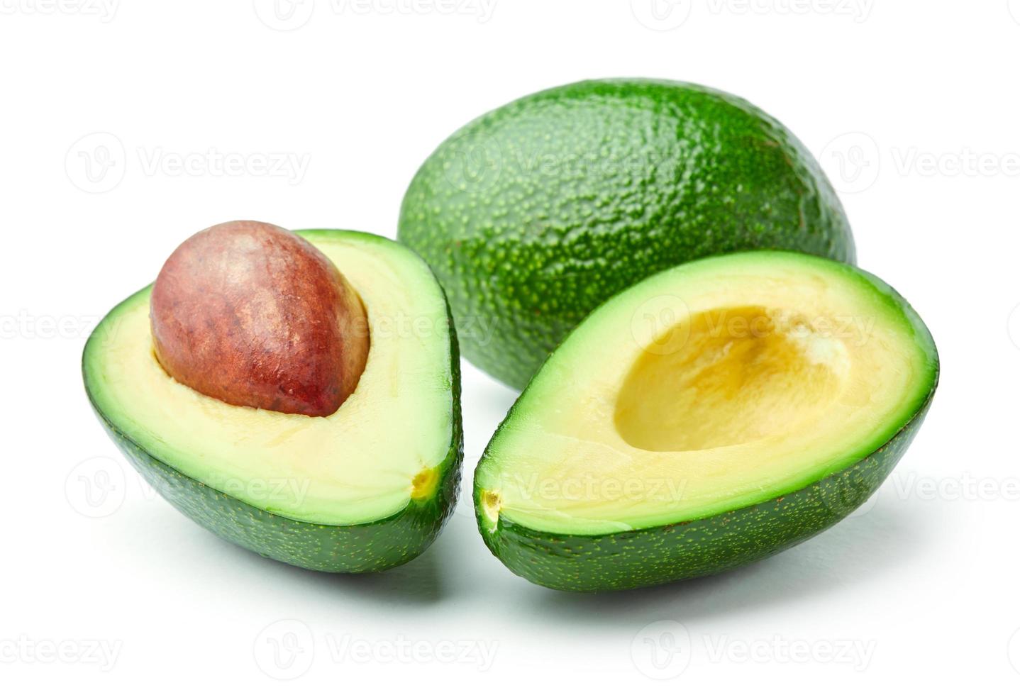 Halved and whole avocados isolated on white background photo