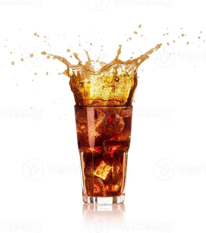 Glass of cola with big splash isolated on white background photo