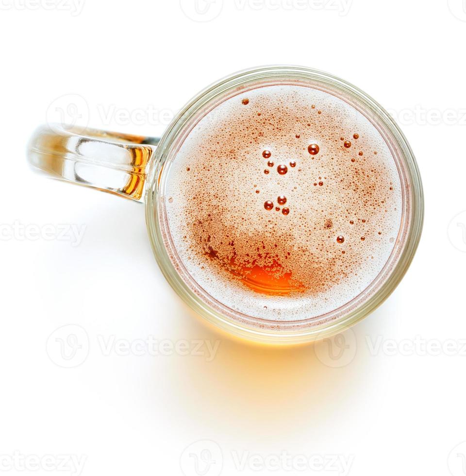 Mug of light beer with foam isolated on white background photo