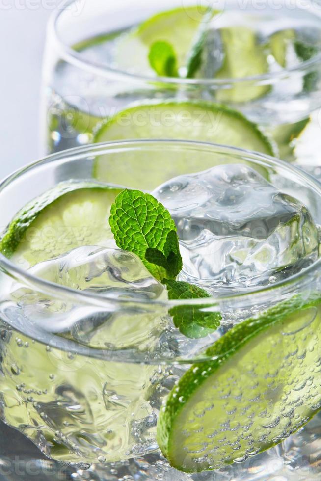 Close-up view of lime cocktails on gray background photo