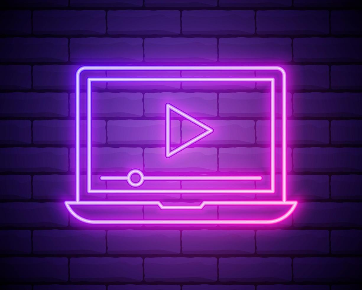 Glowing neon line Online play video icon isolated on brick wall background. Laptop and film strip with play sign. vector